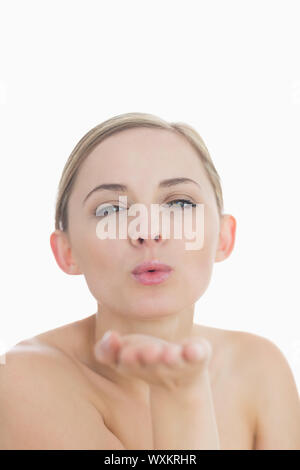 Libre de cute young woman blowing a kiss over white background Banque D'Images