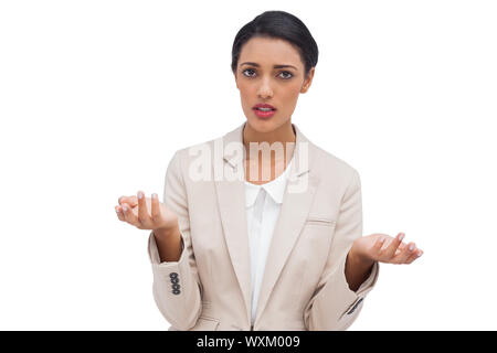 Confus businesswoman standing on white background Banque D'Images