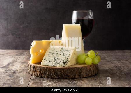 Assortiment de fromages et du vin à table en bois. Banque D'Images