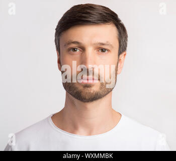 Portrait Of Man Looking at Camera sur fond blanc Banque D'Images