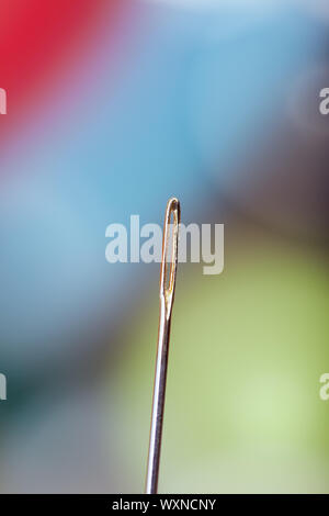 Aiguille à coudre sur un fond coloré. Extrêmement close-up photo Banque D'Images