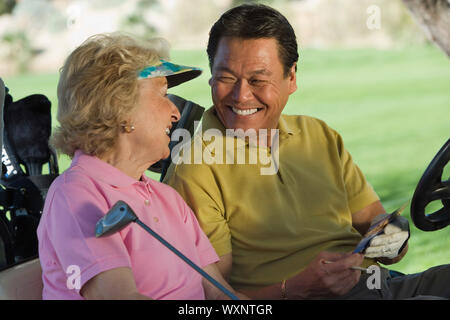 Couple in Golf Cart Banque D'Images