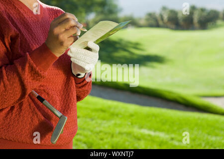 Dans l'écriture de golfeur Scorecard Banque D'Images