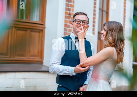 Couple de jeunes mariés en étroite collaboration, de câliner et s'étreindre avec sourires. Ils sont tous heureux de leur mariage. Banque D'Images
