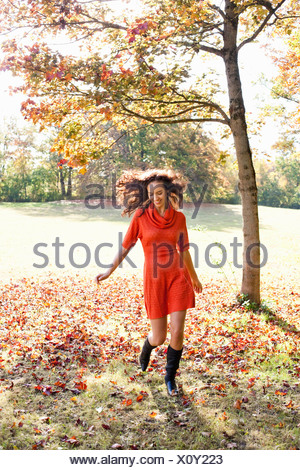 Young woman running in meadow