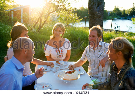 Cinq amis haveing un gâteau, Fejan, archipel de Stockholm, Suède.