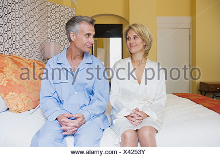 Couple sitting on bed
