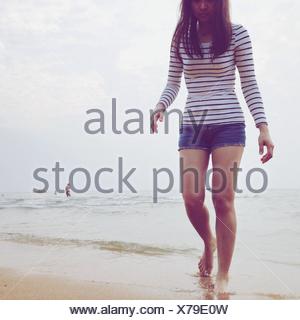 Young Woman Walking On Beach