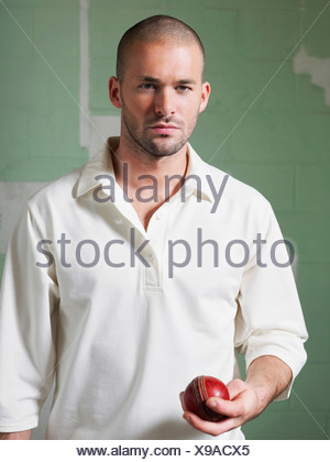 Le Cricket player holding ball, portrait