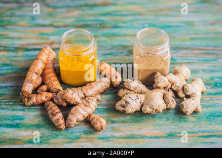 Radice di Zenzero e polvere. Curcuma radice polvere e. Su un colore di sfondo di legno Foto Stock