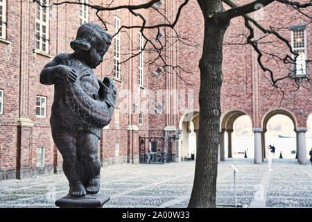 La scultura del ragazzo tenendo il pesce, cortile interno, Stadshuset (Municipio), Kungsholmen, Stoccolma, Svezia Foto Stock