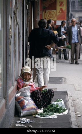 Il 31 maggio 1993 durante l'assedio di Sarajevo: una vecchia signora vende le foglie di vite sul marciapiede opposto alla Pijaca Markale (mercato) sulla mula Mustafe Baseskije nel centro della citta'. Foto Stock