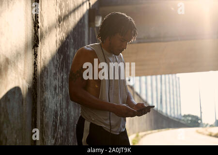 Afro-americano di un uomo guarda il telefono Foto Stock