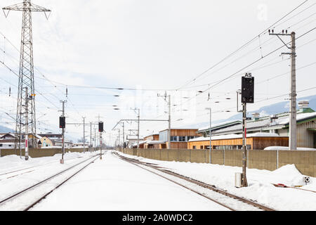 La vista lungo una coperta di neve il binario ferroviario da Bruck - Stazione Fusch, Austria. Bruck e Fusch sono entrambi i comuni in Zell am See distretto. Foto Stock