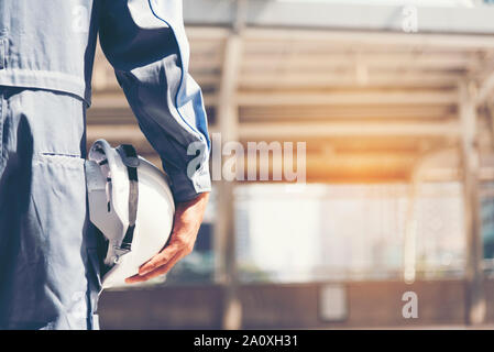 Tecnico delle Costruzioni in tuta di sicurezza fiducia Azienda Team bianco giallo sicurezza elmetto attrezzature di sicurezza sul cantiere. Hardhat proteggere la testa per Foto Stock