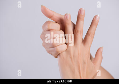 Sanità e medicina concetto. Donna massaggiare la sua dolorosa dito indice. Foto Stock