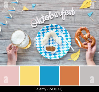 Corrispondenza di colore dalla tavolozza Oktoberfest cibo foto con mano azienda pretzel e di colore bianco-blu decorazioni Foto Stock