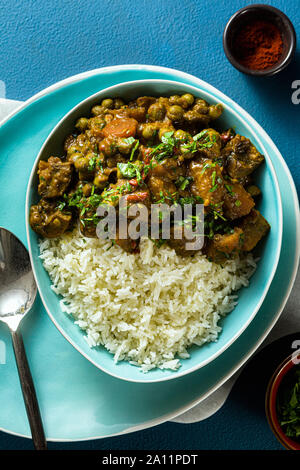 Curry di verdure con zucca e funghi. con riso sul tavolo. sano cibo indiano. ripresa dall'alto. spazio copia Foto Stock