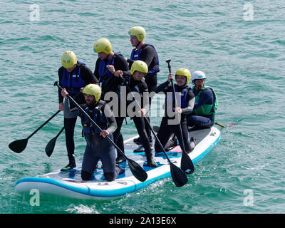 Le donne canottaggio in squadre di sei nei tradizionali costruiti a mano gig pilota barche. l annuale west country evento richiama squadre provenienti da Europa (London Cornish) Foto Stock