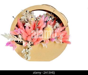 Delicata composizione floristica in bianco pastello colore rosa da fiori secchi in confezione regalo, vicino, isolati su sfondo bianco. Bouquet da soffici Foto Stock
