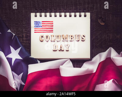 Lettere di legno dell'alfabeto in forma di parole il Columbus Day. Vista superiore, close-up. Preparazione per la vacanza Foto Stock