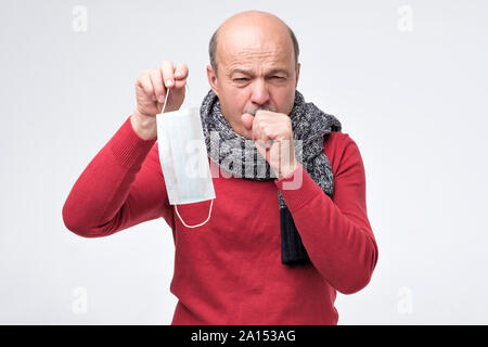 Ispanico uomo maturo avente influenza e tosse. Avendo problemi polmonari. Studio shot Foto Stock