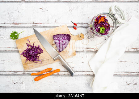 Cavolo rosso, peperoncino, carote e coriandolo sul tavolo di legno Foto Stock