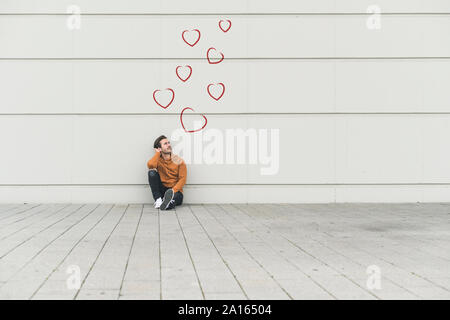 Composito Digitale del giovane uomo a una parete Foto Stock