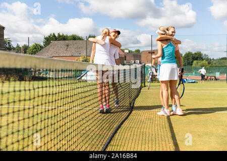 Donne mature la finitura match di tennis su erba corte avvolgente Foto Stock