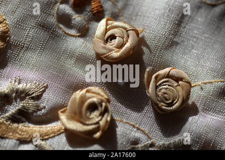 Piccoli fiori, macro dettaglio su una tovaglia ricamata. Foto Stock