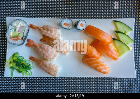 Fresco e delizioso nigiri sushi su ben decorate square piastra bianca Foto Stock
