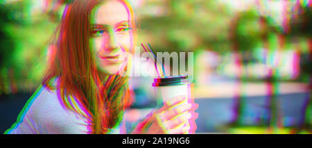 Effetto di glitch. Giovane bella ragazza di bere il caffè nel parco. Copia banner space Foto Stock