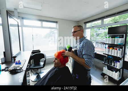 Parrucchiere maschio e femmina in client parrucchiere Foto Stock