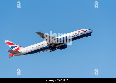 British Airways Boeing 777 aereo di linea G-YMMA decolla dall'aeroporto di Londra Heathrow, Londra, Regno Unito in cielo blu Foto Stock