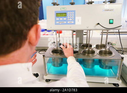 Università di Newcastle studente di dottorato di ricerca Max Kelly, 24, all'Benton e Proctor Gamble sito in Newcastle, aggiunge segmenti di materiale per un laboratorio controllato 'mini' macchine di lavaggio per la misurazione del rilascio di microfibre durante diversi cicli di lavaggio. Foto Stock