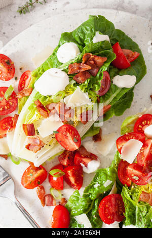 Lattuga romana condito con pomodoro pancetta parmigiano, salsa. sano cheto paleo dieta pranzo Foto Stock