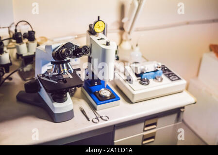 Un esempio di tabella di preparazione in microscopia aelecron laboratorio con un microscopio ottico, taglierina ad ultrasuoni e sistema Precision smerigliatrice micrometro pol Foto Stock