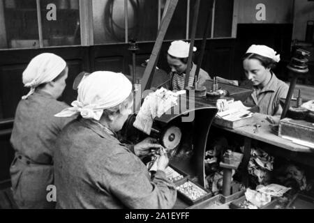 Herstellungsprozess von Silberringen in einer Ringfabrik in Hanau, Assia, 1930er. Procedimento per la produzione di anelli d'argento in un anello manufactory in Hanau, Hesse, 1930s. Foto Stock