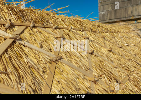 Recentemente ristrutturato e rinnovato di paglia di paglia sul tetto di un villaggio cottage dopo la riparazione e rinnovo compresa sostituzione tetto di cresta Foto Stock