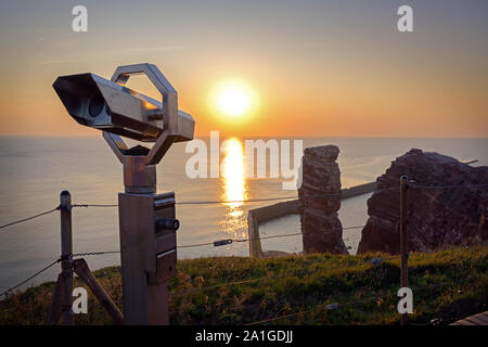 Telescopio pubblico alla Lange Anna, il famoso mare rock di stack di Helgoland con il tramonto sul mare del nord, spazio copia selezionata, focus, stretti o di profondità Foto Stock