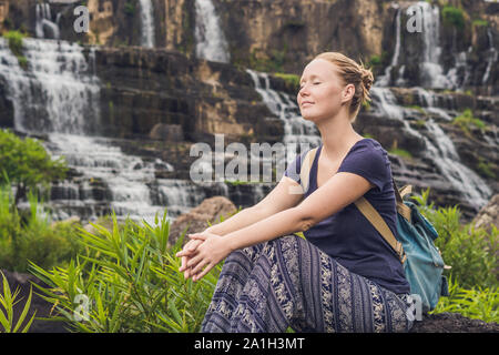 Giovane donna escursionista, turistico sullo sfondo di incredibile cascata Pongour è famosa e più belli di cadere in Vietnam. Non lontano dalla città di Dalat est Foto Stock