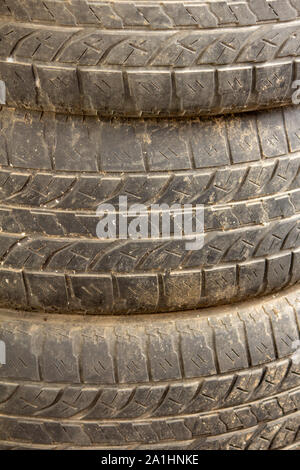 Vista di vecchi pneumatici accatastati uno sull'altro. Foto Stock