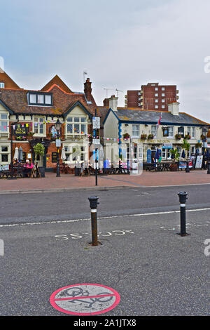 La gente seduta al di fuori del pub lungo il porto di Poole, compreso il Jolly Sailor e il Lord Nelson. Foto Stock