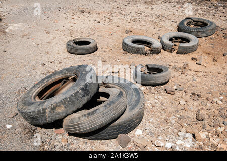 Vecchia auto pneumatici oggetto di pratiche di dumping nel paesaggio del deserto Foto Stock