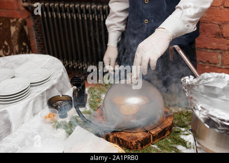 Lo chef è il fumo un piatto prima di servire, moderna tecnica di cottura Foto Stock
