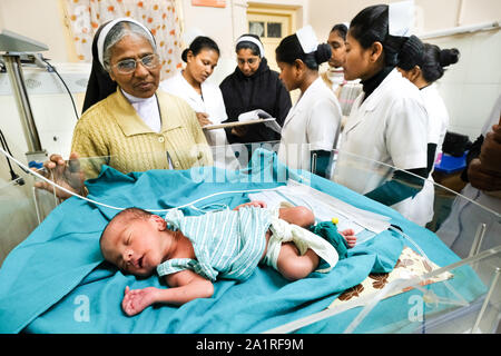 Medici e infermieri sorelle al letto di un bambino prematuro nella chiesa cattolica Seva Nidas ospedale in Dhekiajulil. Stato federale Assam, il Nordest dell India, Asia Foto Stock