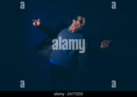 Ritratto di cool bello attraente allegro funny funky posizione impermeabili Foto Stock