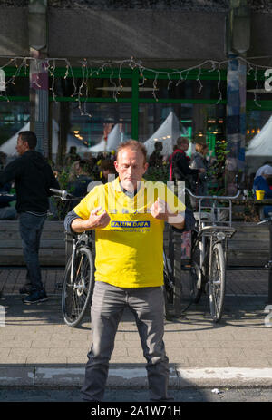 Sint Niklaas, Belgio, 8 settembre 2019, uomo praticato Falun Dafa, rendendo un pugno e solleva le braccia in avanti Foto Stock