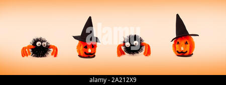 Artigianato Halloween home decorazioni e ornamenti, teste di strega arancione su sfondo panoramico Foto Stock