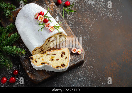 Natale Stollen. Tradizionale tedesco, festiva europea Dessert. Concetto di vacanza decorate con rami di abete. Foto Stock